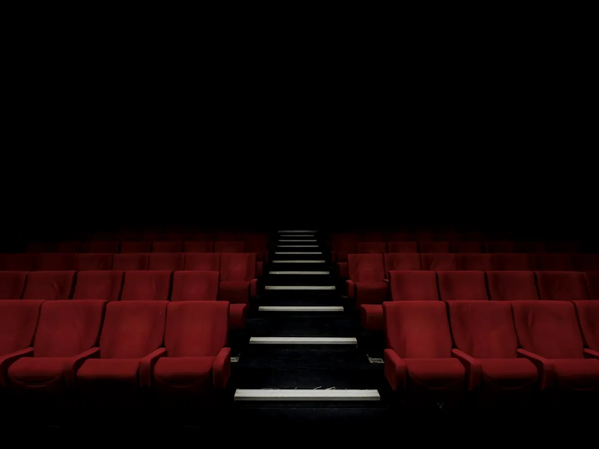 Cinema seats facing a large screen